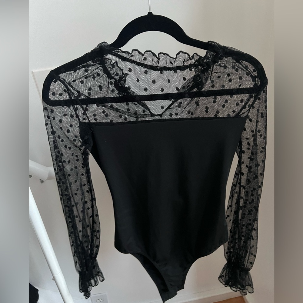 Black polka dot bodysuit.